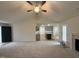 Cozy living room with modern amenities with an open transition to a kitchen with gray cabinets and stainless appliances at 151 Oakfield Trace Dr, Four Oaks, NC 27524