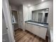 Bathroom features double vanity with granite counters and wood-look floors at 188 Oakfield Trace Dr, Four Oaks, NC 27524