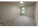 Neutral bedroom features a window and carpeted floors at 188 Oakfield Trace Dr, Four Oaks, NC 27524