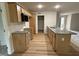 Functional kitchen with light wood cabinets, granite countertops, stainless appliances and wood-look floors at 188 Oakfield Trace Dr, Four Oaks, NC 27524