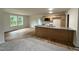 Kitchen with light wood cabinets, granite countertops, a large island, and stainless steel appliances at 188 Oakfield Trace Dr, Four Oaks, NC 27524