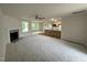 Open-concept living room with a fireplace that flows into the kitchen featuring an island and ample space at 188 Oakfield Trace Dr, Four Oaks, NC 27524