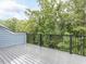 Balcony with gray composite decking and black metal railing with wooded view at 2008 Van Hook Ln, Apex, NC 27502