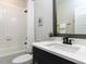 Bathroom featuring a shower-tub combo, modern vanity, and neutral walls at 2008 Van Hook Ln, Apex, NC 27502