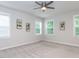 Spacious carpeted bedroom with neutral walls, ceiling fan, and bright natural light at 2008 Van Hook Ln, Apex, NC 27502