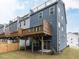 Exterior view of townhomes with decks and blue siding at 2008 Van Hook Ln, Apex, NC 27502