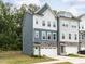 Beautiful two-story townhome with a two-car garage and a well-manicured lawn at 2008 Van Hook Ln, Apex, NC 27502