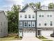 Charming townhome featuring a stone facade, attached garage, and a welcoming front entrance at 2008 Van Hook Ln, Apex, NC 27502