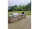 Outdoor grilling area featuring built-in stainless steel grills and stone counters, perfect for community gatherings at 2008 Van Hook Ln, Apex, NC 27502