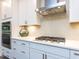 Close-up of a modern kitchen showcasing white cabinets, stainless steel appliances, and tile backsplash at 2008 Van Hook Ln, Apex, NC 27502