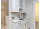 Kitchenette featuring white cabinets, wine wrack and brass hardware at 2008 Van Hook Ln, Apex, NC 27502