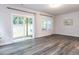 Open living room with hardwood floors, neutral walls, and sliding glass doors to the backyard at 2008 Van Hook Ln, Apex, NC 27502