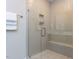 Modern shower with tiled walls, glass doors, built-in shelving, and a seating bench at 2008 Van Hook Ln, Apex, NC 27502