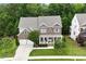 Beautiful brick front home with an attached two-car garage surrounded by mature trees and green grass at 213 Preatonwood Dr, Apex, NC 27539