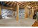 Spacious unfinished basement with exposed beams and wrapped walls, ready for customization at 213 Preatonwood Dr, Apex, NC 27539