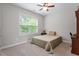 Bedroom featuring a large window with natural light and neutral carpet at 213 Preatonwood Dr, Apex, NC 27539