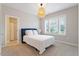 Light-filled bedroom with a cozy bed and view from large windows at 213 Preatonwood Dr, Apex, NC 27539