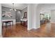 Open-concept entryway showcasing hardwood floors, modern lighting, and seamless flow to the dining area at 213 Preatonwood Dr, Apex, NC 27539