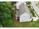 A side view of a light grey home shows a screened-in porch and lush landscaping at 213 Preatonwood Dr, Apex, NC 27539