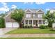 Beautiful two-story brick home with a welcoming front porch and manicured lawn at 213 Preatonwood Dr, Apex, NC 27539