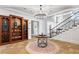 Grand foyer features staircase, wood floors, decorative rug, and stylish chandelier at 213 Preatonwood Dr, Apex, NC 27539