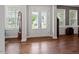 Inviting foyer with hardwood floors, glass panel entry doors and views to the outside at 213 Preatonwood Dr, Apex, NC 27539