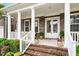 Close-up of a front porch with brick steps and white pillars at 213 Preatonwood Dr, Apex, NC 27539