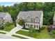 Attractive brick home with a welcoming front porch, landscaped lawn, and attached garage at 213 Preatonwood Dr, Apex, NC 27539