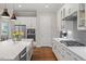 Modern kitchen featuring stainless steel appliances, stone countertops and glass paneled cabinets at 213 Preatonwood Dr, Apex, NC 27539