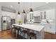 Spacious kitchen with stainless steel appliances, white cabinetry, and a large center island at 213 Preatonwood Dr, Apex, NC 27539