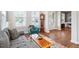 Bright living room featuring an accent chair, hardwood floors, and large windows at 213 Preatonwood Dr, Apex, NC 27539