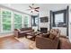 Inviting living room with a fireplace, tv and plenty of natural light at 213 Preatonwood Dr, Apex, NC 27539