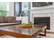 Comfortable living room with a fireplace, neutral colors, and a decorative coffee table at 213 Preatonwood Dr, Apex, NC 27539