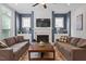 Comfortable living room featuring a fireplace with a tv, cozy seating, and stylish decor at 213 Preatonwood Dr, Apex, NC 27539
