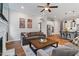 Open-concept living area with a kitchen, large windows, and comfortable seating at 213 Preatonwood Dr, Apex, NC 27539