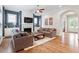 Open living room with a fireplace, hardwood floors, and seamless flow to the kitchen at 213 Preatonwood Dr, Apex, NC 27539