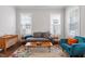 Comfortable living room with cozy furniture and ample natural light from large windows at 213 Preatonwood Dr, Apex, NC 27539