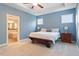 Main bedroom with en suite bathroom access, tray ceiling, and carpet at 213 Preatonwood Dr, Apex, NC 27539