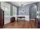 Office features hardwood floors, large windows, and a stylish light fixture at 213 Preatonwood Dr, Apex, NC 27539