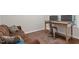 Office area with a brown futon, metal desk and chair, and lots of natural light at 213 Preatonwood Dr, Apex, NC 27539