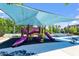 View of the community playground under a large awning, perfect for outdoor fun at 213 Preatonwood Dr, Apex, NC 27539