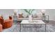 Bright living room with neutral walls, large window, stylish furniture, and decorative rug over wood-look flooring at 2134 Monk Dr, Haw River, NC 27258