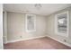 Empty bedroom with two windows and pink carpet; ready for personalization at 230 Park Ave, Rocky Mount, NC 27801