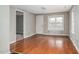 Bright living room featuring hardwood floors, neutral paint, and a large window, offering a welcoming space at 230 Park Ave, Rocky Mount, NC 27801