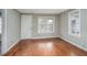 Open living room with beautiful hardwood floors, bright windows, and fresh paint, ready for personal touches at 230 Park Ave, Rocky Mount, NC 27801