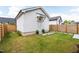 Charming backyard featuring a green lawn, white storage building, and a stone path leading to the building at 248 Daniel Ridge Rd, Wendell, NC 27591