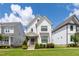 Beautiful two-story home featuring white siding, black-framed windows, and a well-manicured lawn on a sunny day at 248 Daniel Ridge Rd, Wendell, NC 27591