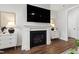 Living room with a sleek fireplace, modern lighting, and decorative art at 248 Daniel Ridge Rd, Wendell, NC 27591