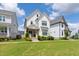 Beautiful two-story home with a covered front porch, wood columns, lush landscaping and a well-manicured lawn at 248 Daniel Ridge Rd, Wendell, NC 27591