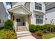 Charming front porch with wood columns, brick stairs, and manicured landscaping at 248 Daniel Ridge Rd, Wendell, NC 27591